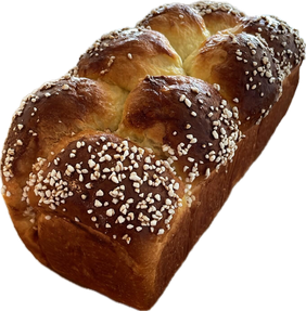 A braided brioche loaf topped with pearl sugar