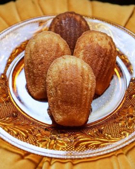 Four madeleines on an amber pressed-glass plate