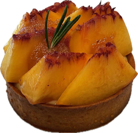A tartlet topped with wedges of yellow peach and a sprig of rosemary
