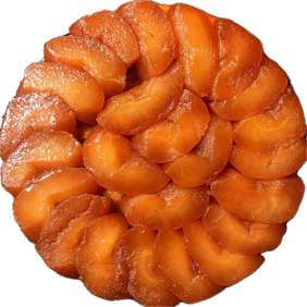 A tarte tatin with caramelised apple slices arranged in a spiral, seen from above